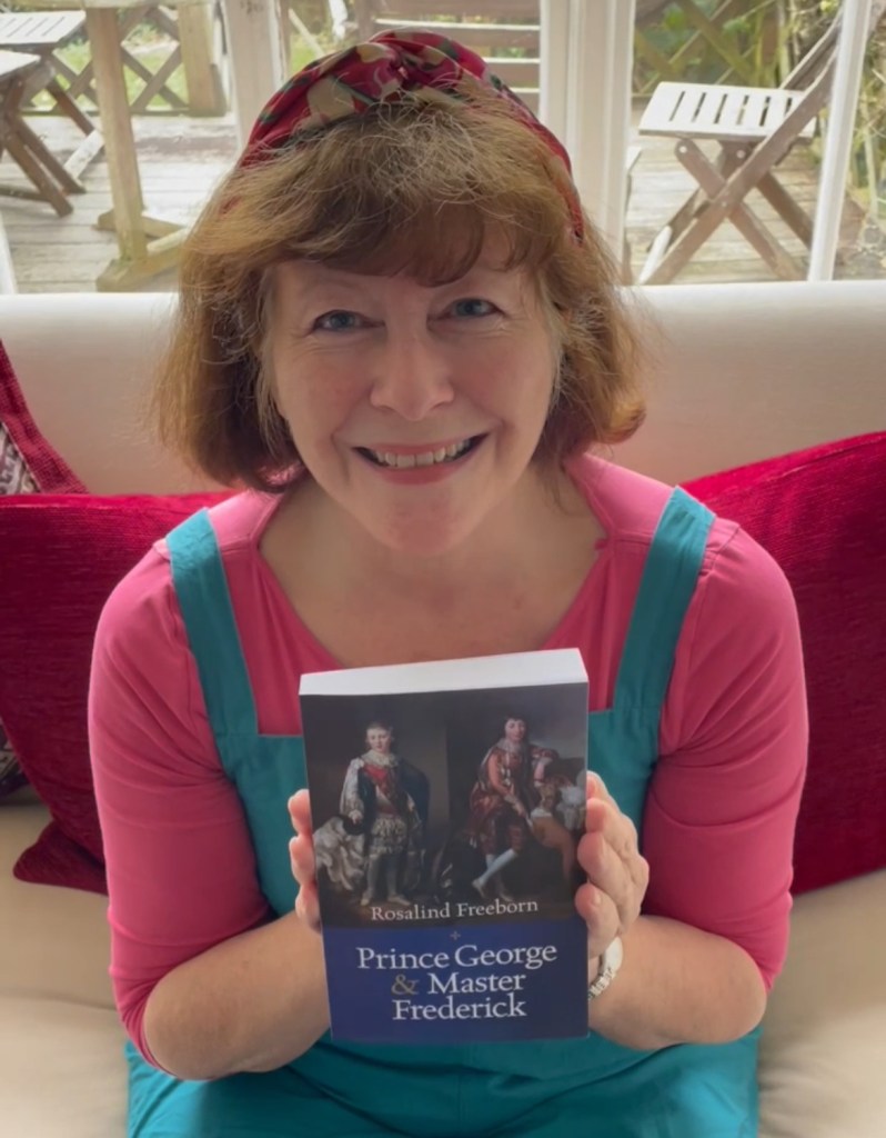Photo of Rosalind Freeborn, author of Prince George & Master Frederick with a copy of her historical novel due to be published on 30th January 2025. 